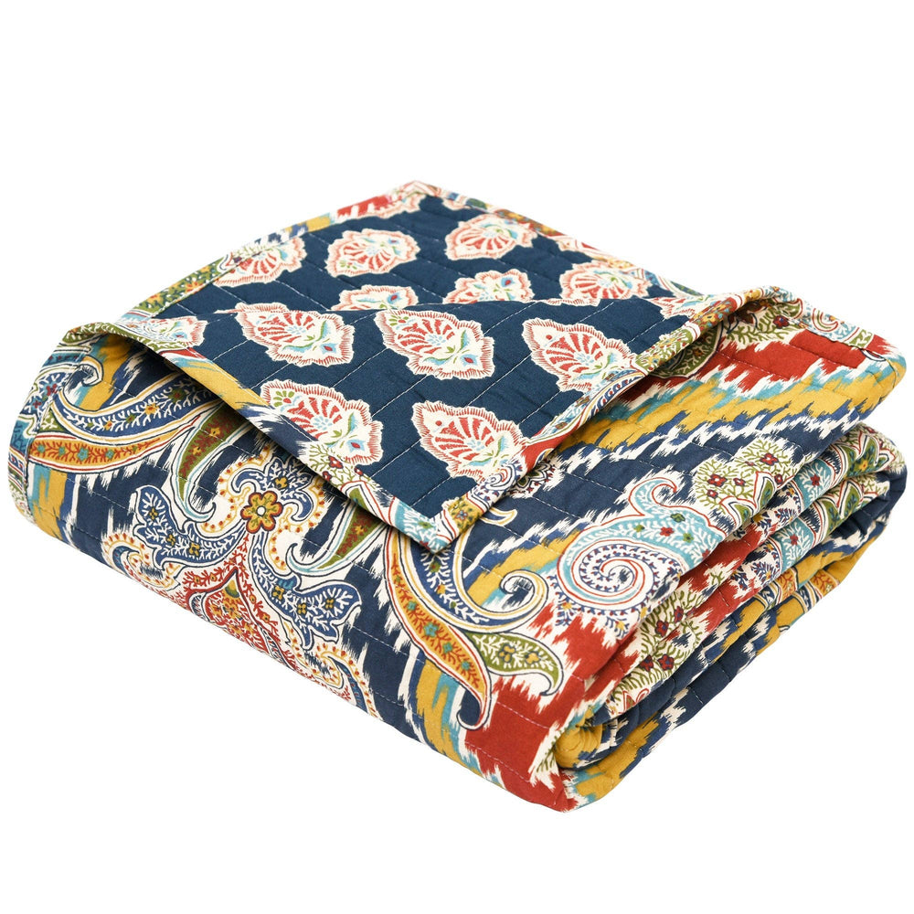 Colorful paisley-patterned quilt on a white background